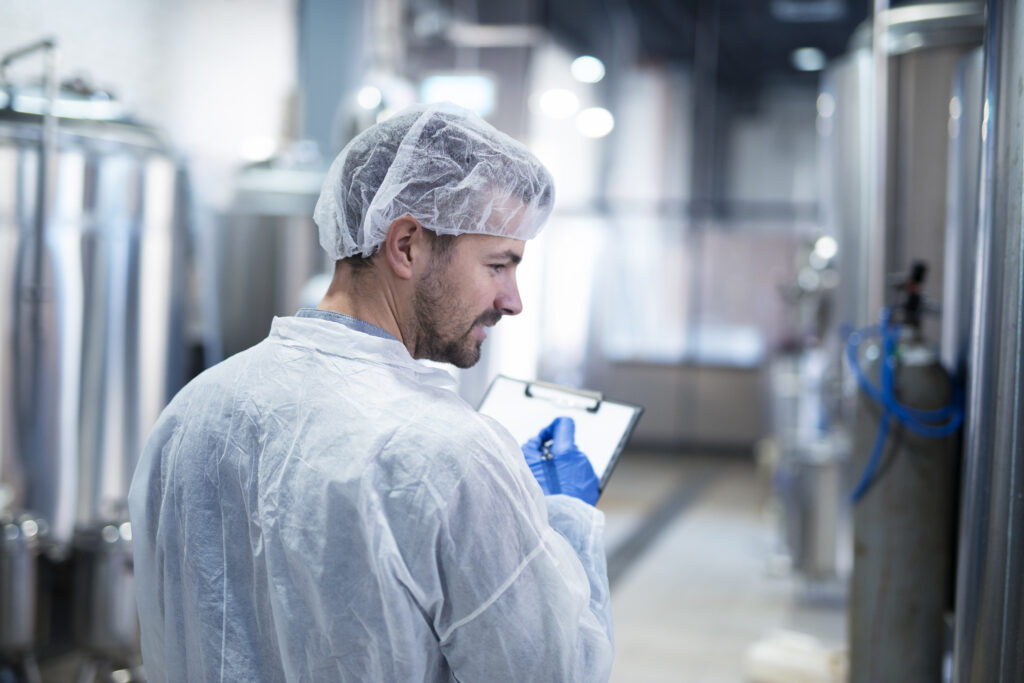 Technologist controlling production in factory.